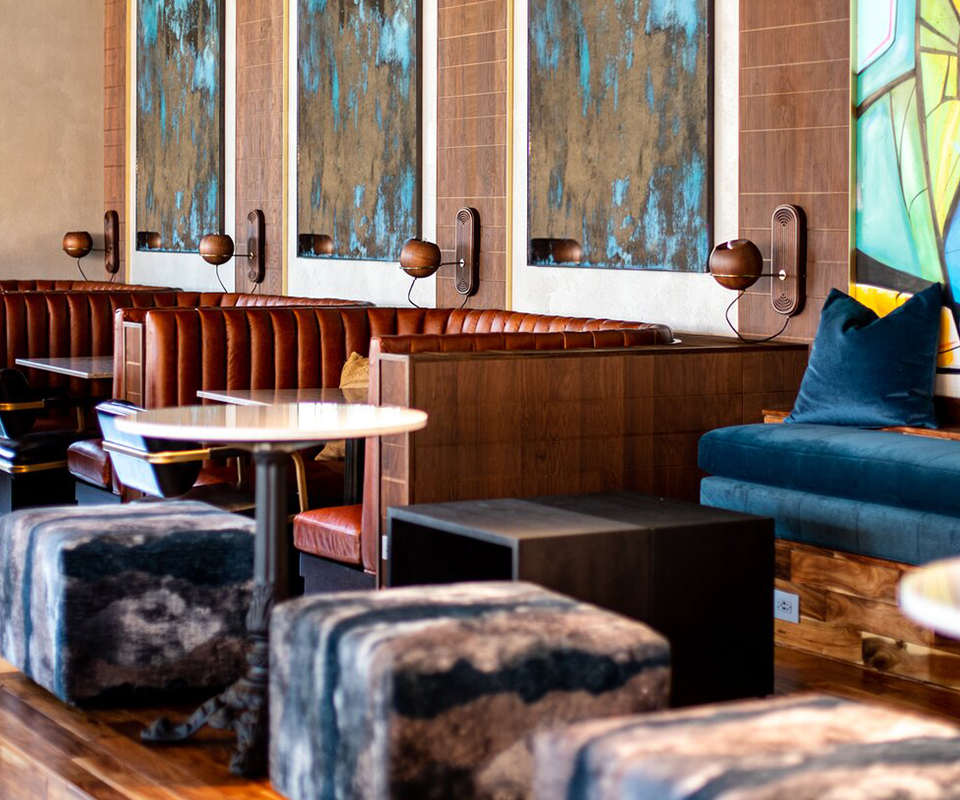 Multiple Fleming Wall Lamps provide warm illumination to the cozy booths and seating areas of this establishment at Canopy by Hilton Memphis Downtown