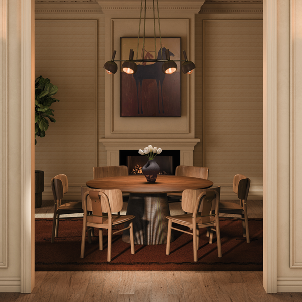 Elegant dining room setup with Arthur Dining Chairs surrounding Henry a round wooden dining table, framed by warm interior lighting, a fireplace, and hanging the essen suspesion lamp.
