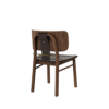 Back three-quarter view of the Arthur Dining Chair in dark walnut wood, highlighting the dark brown leather upholstered seat, curved wooden backrest, dark saddle leather back strap, and aged brushed brass bar and button detail.