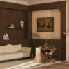 Brinsley Bar Cart, Wood Tailors' New Icon in a living room setting, made of walnut wood and rattan, placed next to a Dudley sofa upholstered in white with smoked walnut wood accents. The room is softly lit by natural light from a window, highlighting the wooden walls and ceiling plaster décor.”