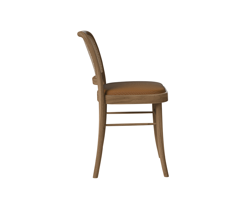 Side profile of the Charles I Dining Chair showing the elegant curve of the backrest, clean wooden leg structure, and padded cognac leather seat.