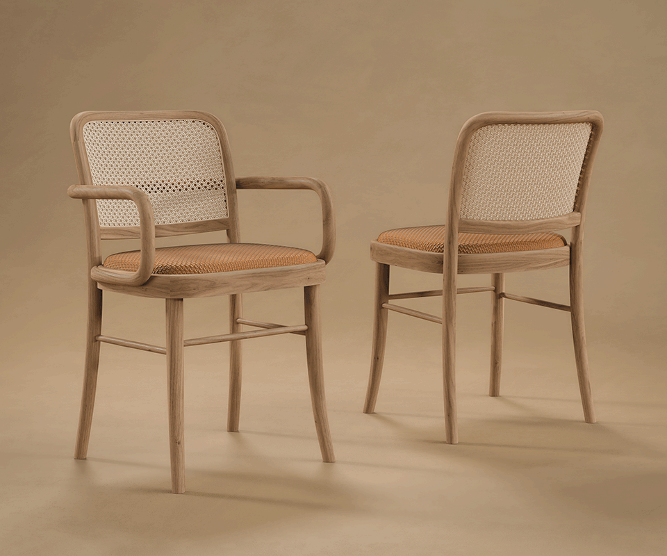 Two Charles dining chairs by Wood Tailors Club featuring light and dark wood frames, woven cane backs, and patterned fabric seats on a neutral beige background — charles II dining chair with armrests viewed from the front-three-quarter angle and charles I dining chair armless viewed from the back.
