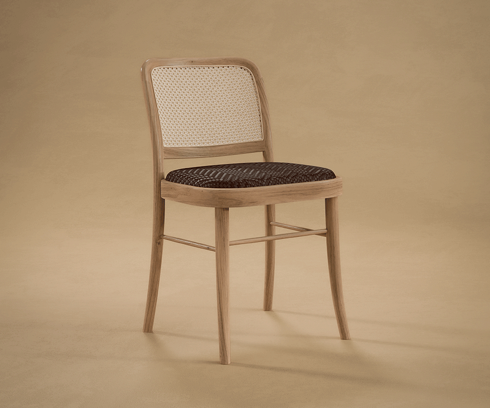 Lifestyle view of the Charles I Dining Chair featuring a natural wooden frame, dark brown and light brown braided leather seat, and woven rattan backrest in a warm studio setting.