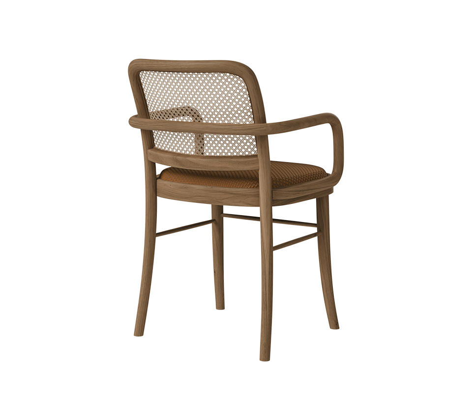 Three-quarter rear view of the Charles II Dining Chair by Wood Tailors Club displaying the handcrafted wooden frame structure, cane rattan backrest detail, and cognac seat cushion.