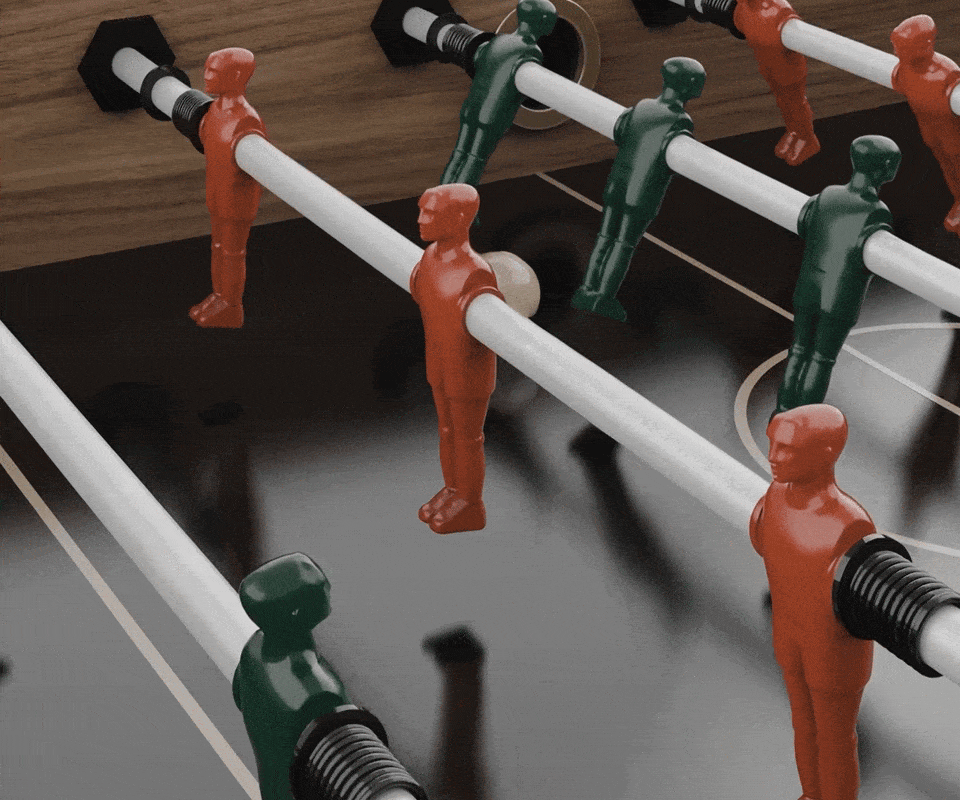 Close-up view of the red and green steel foosball players on the Chesterfield luxury game table.
