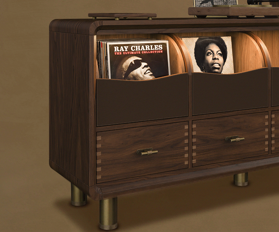 Deatil tree-quarter view of the Edward Sideboard by Wood Tailors Club crafted in dark stained smoked walnut, displaying vinyl storage compartments, drawers with brass hardware.