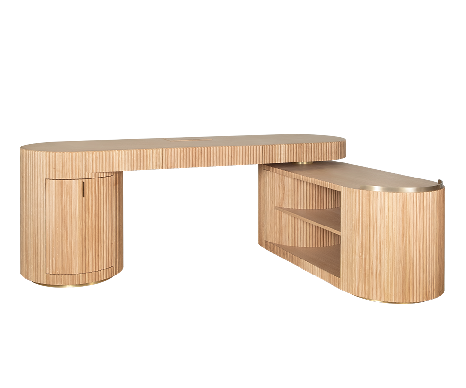 Gifford Desk Gifford desk by Wood Tailors Club. Angle view of an L-shaped configuration, with an oak desk, an oak fluted-panel cabinet on the far left, and a lower, rotating oak shelf module with two open shelves extended to the far right. Brass detailing is visible at the bases and shelf trim.