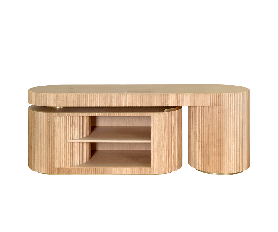 Gifford Desk Gifford desk by Wood Tailors Club in oak. Front view of the desk in its closed configuration, showing the main oak desktop over the fluted oak cabinet on the left and the fully retracted fluted oak shelf module on the right. Both curved elements feature brass base accents.