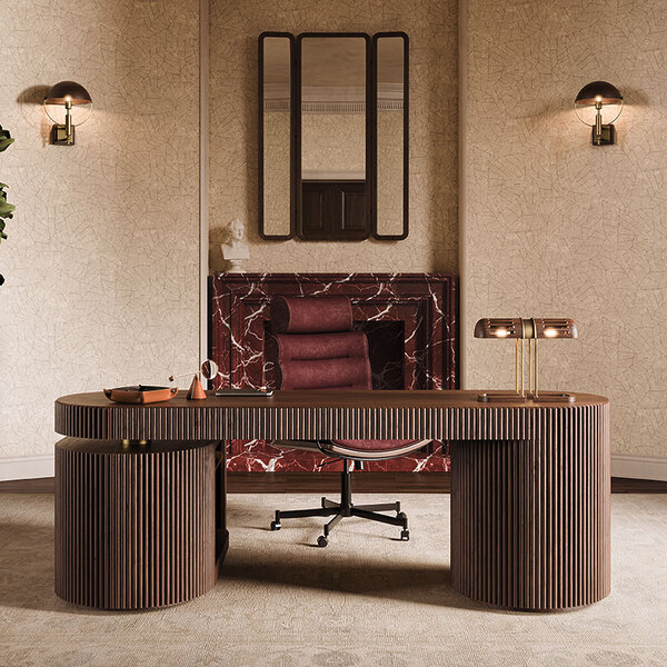 Office Edition: Home office interior featuring the Gifford desk in smoked walnut wood with a Turing table lamp on top, paired with the Thomas office chair upholstered in bordeaux leather. In the background, a marble fireplace with the Tom folding mirror above it is flanked by two illuminated Faraday wall lamps.