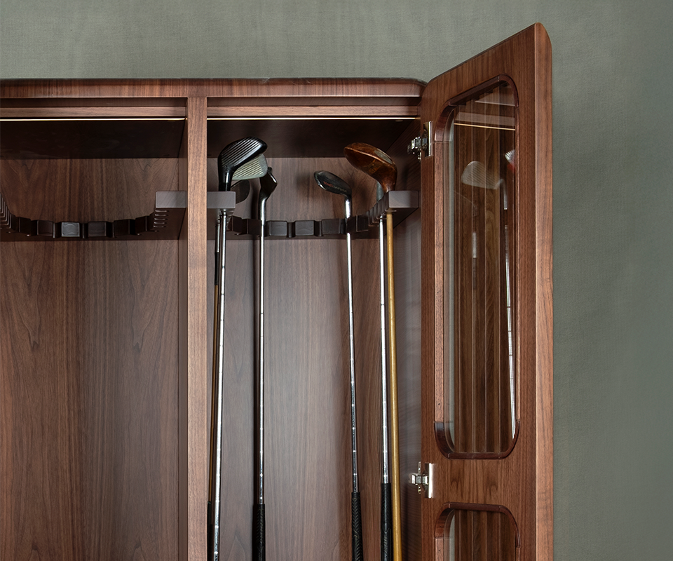 Kennedy Golf Locker A detailed view of the upper interior of the smoked walnut Kennedy Golf Locker, showing various golf clubs (drivers and irons) securely resting in the custom-carved wooden hanging system.