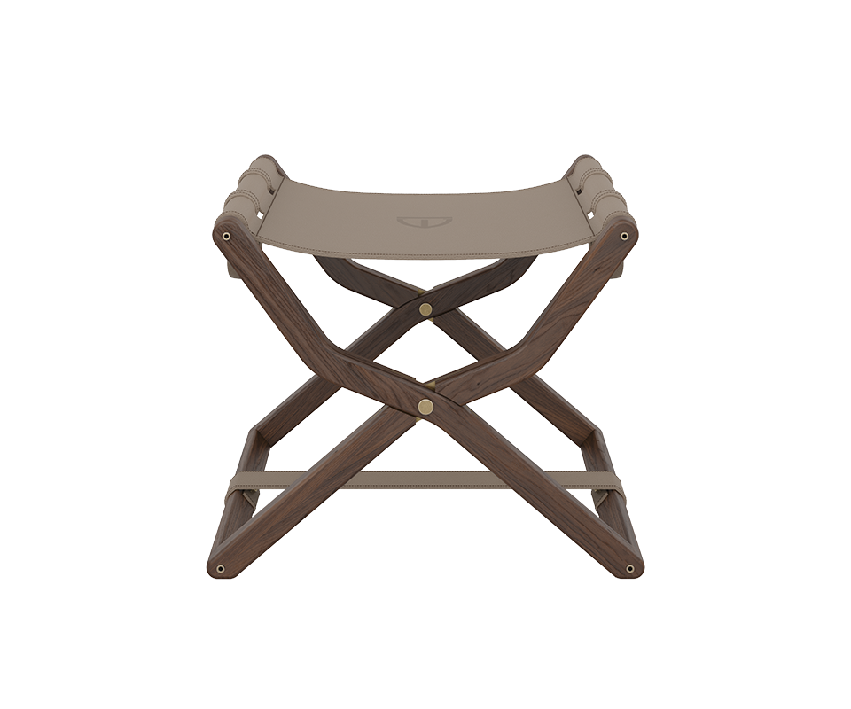 Front-facing symmetrical view of the Korda stool, showcasing the X-shaped walnut wood frame and a taupe leather seat held by stitched leather loops.