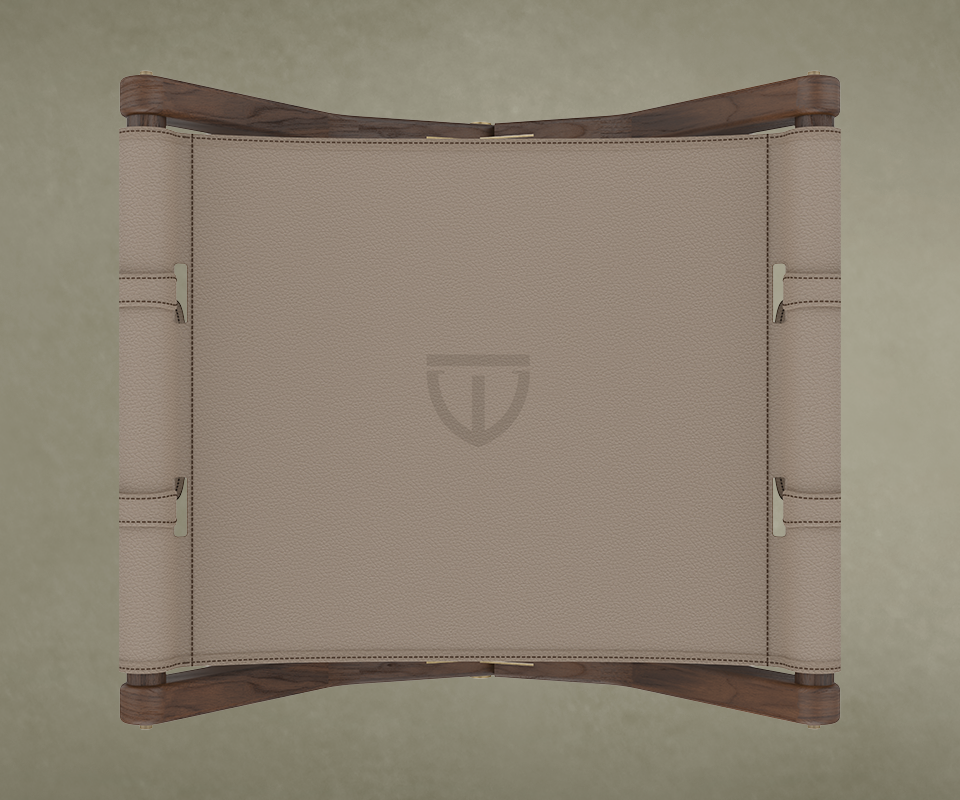Top-down close-up of the Korda seat, showing the fine grain of the taupe leather and the discreetly embossed Wood Tailors Club logo in the center.
