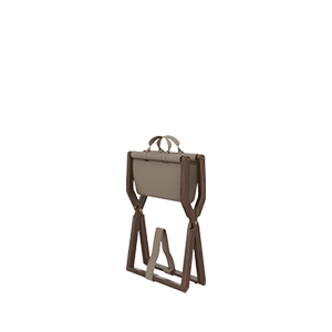 Angled view of the Korda stool in its folded position, demonstrating its portability and the functional leather carry handles at the top.