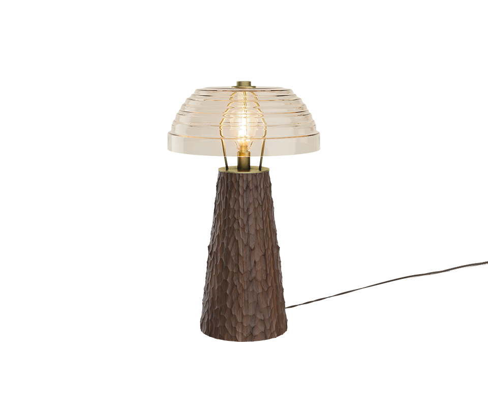 A studio shot of the Lloyd I Table Lamp featuring a medium-brown chiseled wood base, a brass bulb holder, and an elegant transparent ribbed glass dome shade with its power cord extending to the right.