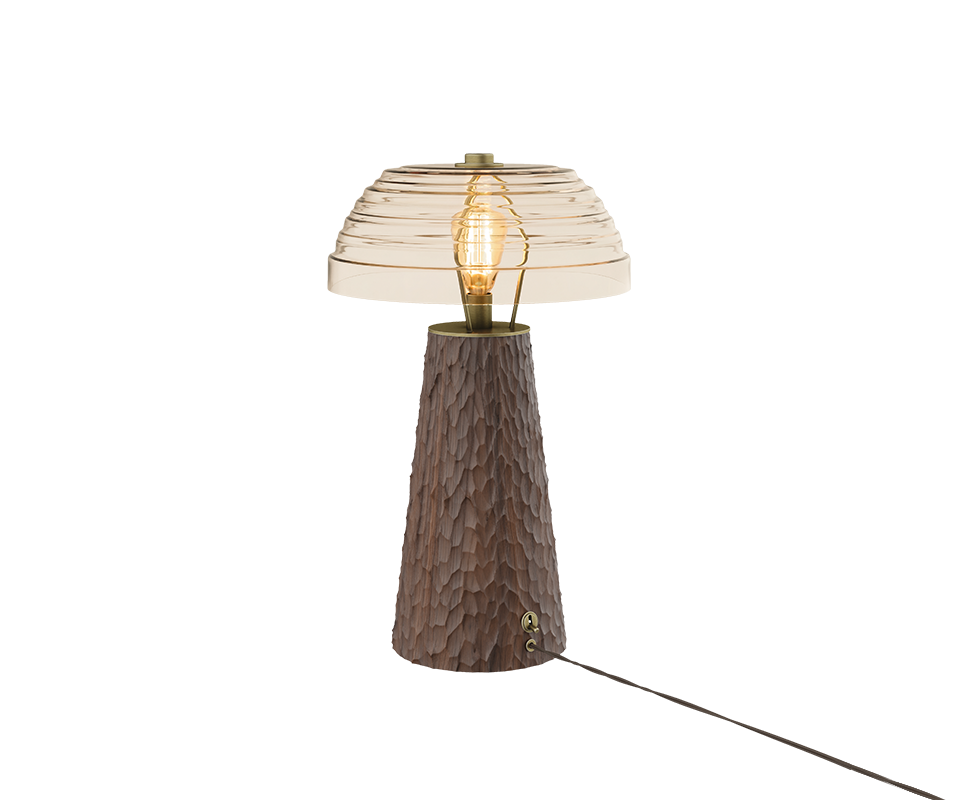 A studio shot of the Lloyd I Table Lamp angled to show a rich dark brown hammered wood base, complete with its vintage-style brass toggle switch and power cord attached near the bottom.