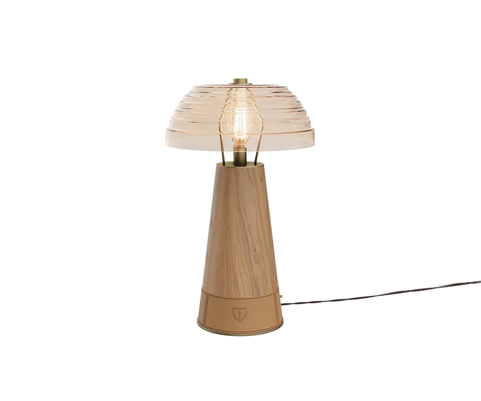 Studio shot of the Lloyd Table Lamp featuring a extra clear glass dome shade. The conical base is crafted from oak, finished at the bottom with stitched leather wrap displaying a subtle woodtailors club emblem.