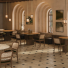 New Dining Solutions, Crafted in Portugal stuart II dining table ambiente 1 Luxurious restaurant dining room furnished with multiple Stuart I Dining Tables by Wood Tailors Club, paired with wooden chairs with woven backrests, plush banquette seating, arched windows, and warm pendant lights.