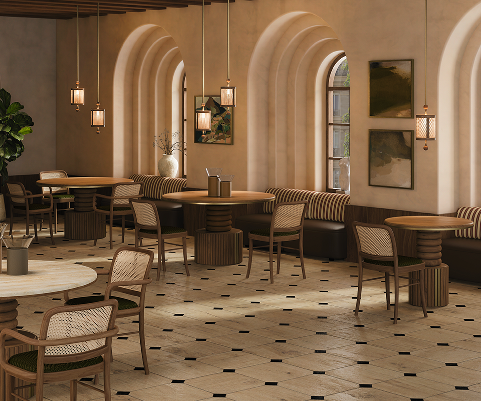 Luxurious restaurant dining room furnished with multiple Stuart I Dining Tables by Wood Tailors Club, paired with wooden chairs with woven backrests, plush banquette seating, arched windows, and warm pendant lights offer new dining solutions.